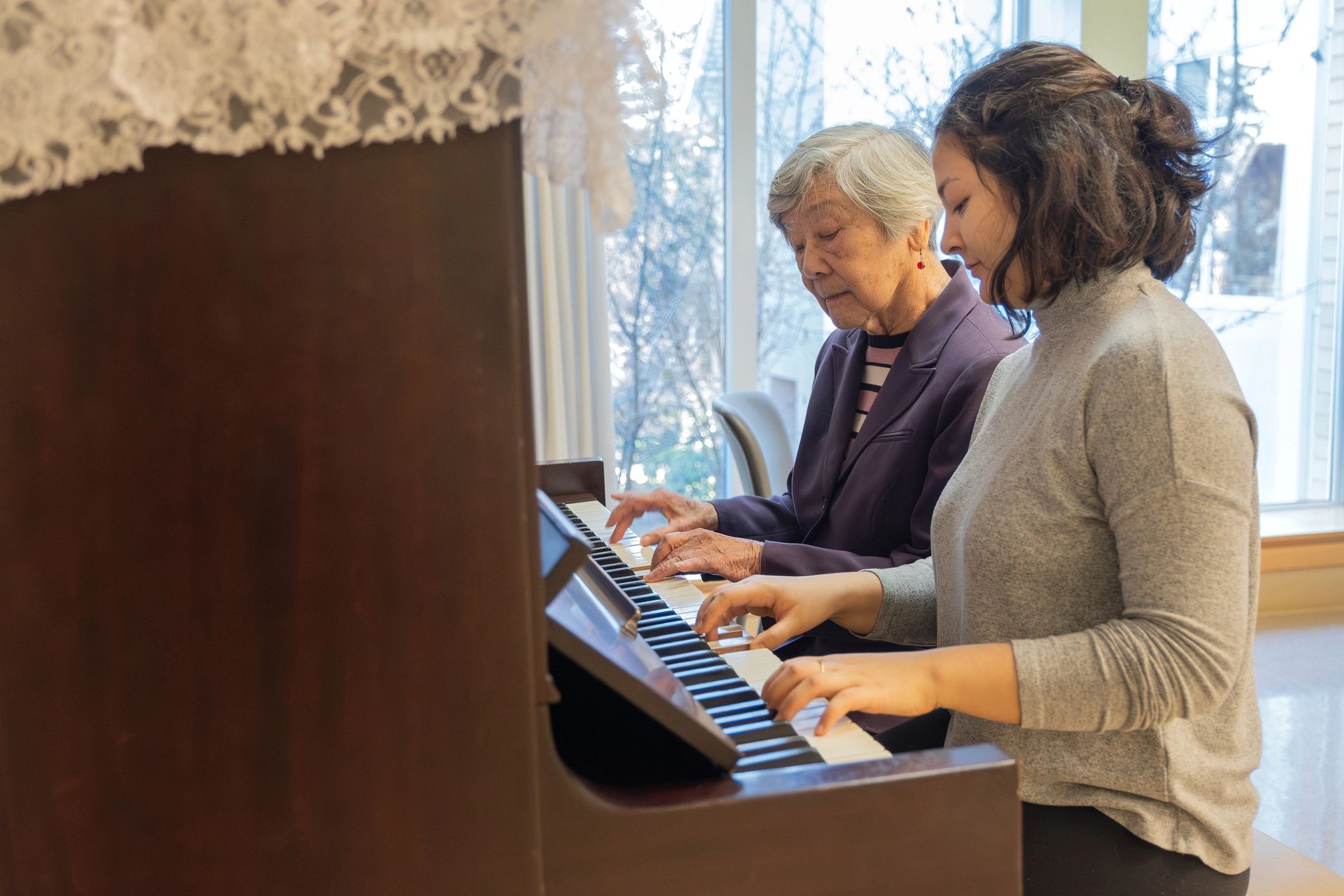 Student learning piano during a lesson