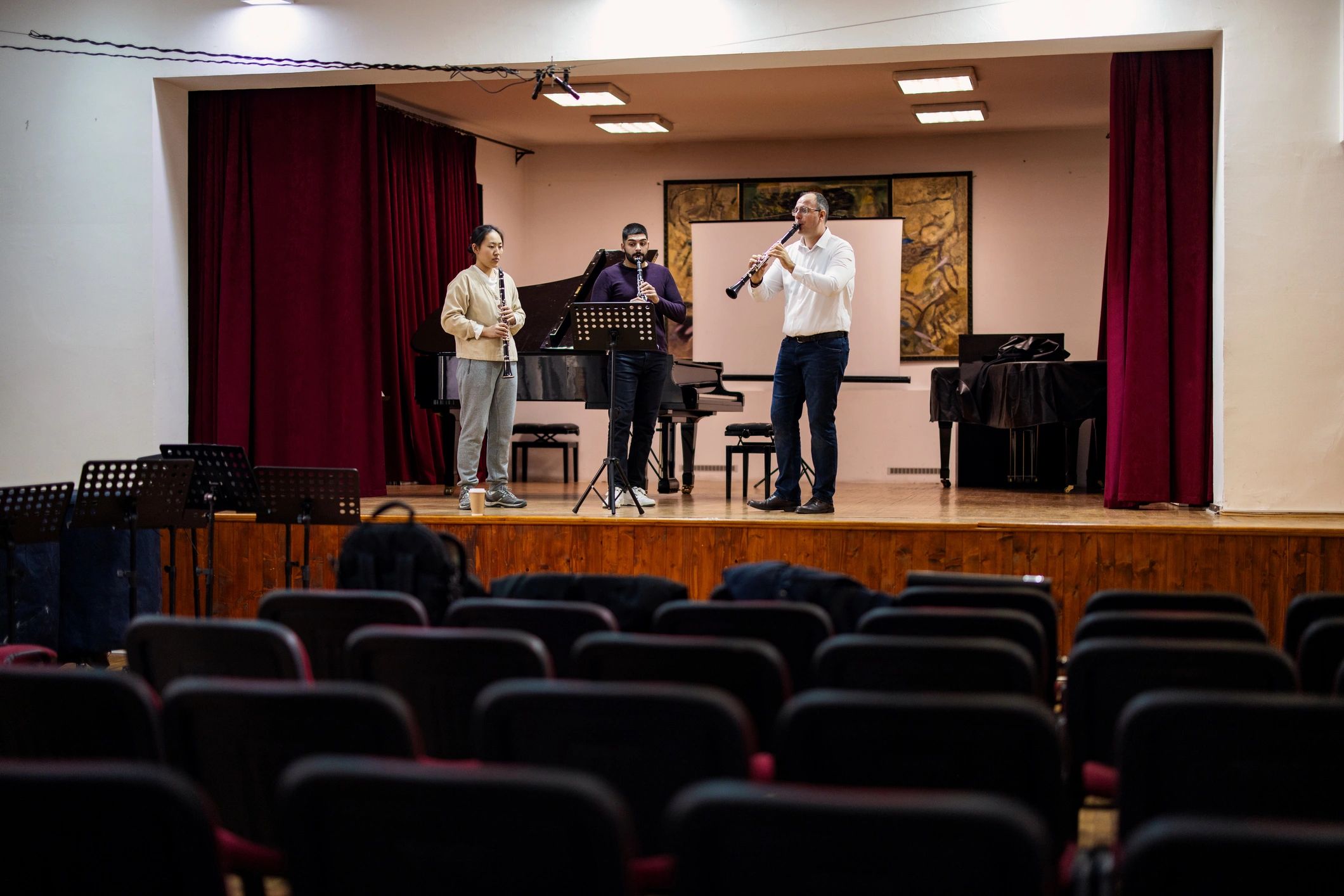 Music teacher guiding students in an academy classroom